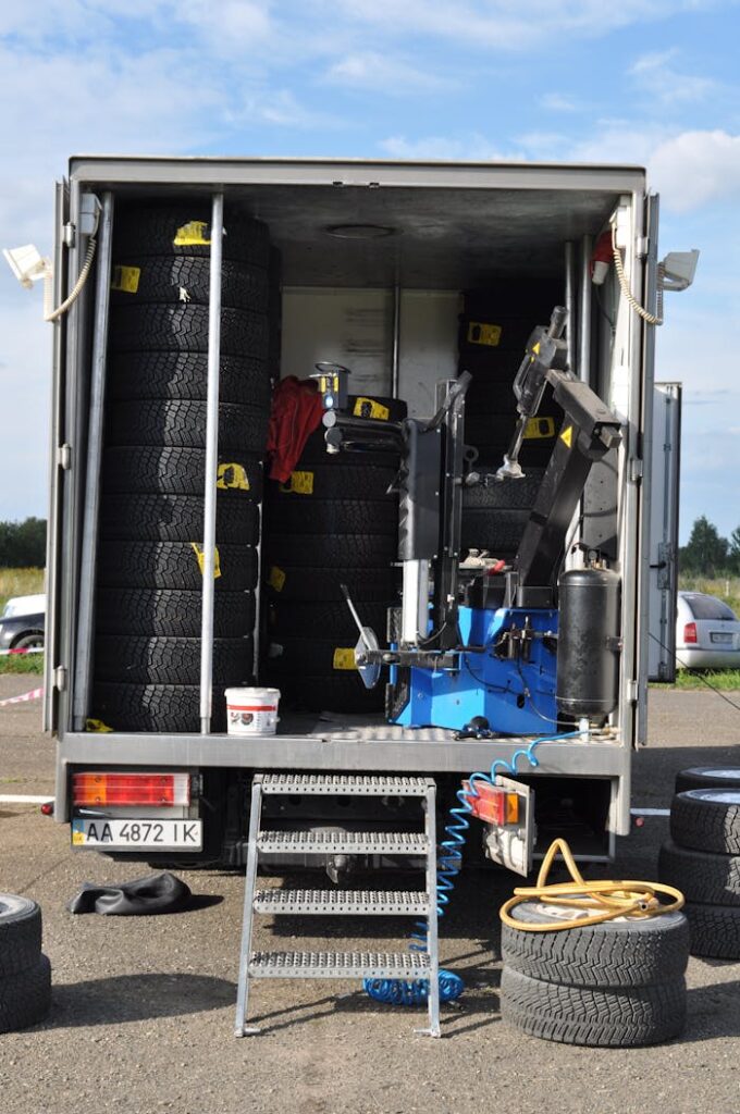 A mobile tire repair truck stocked with tires and machinery for roadside assistance.